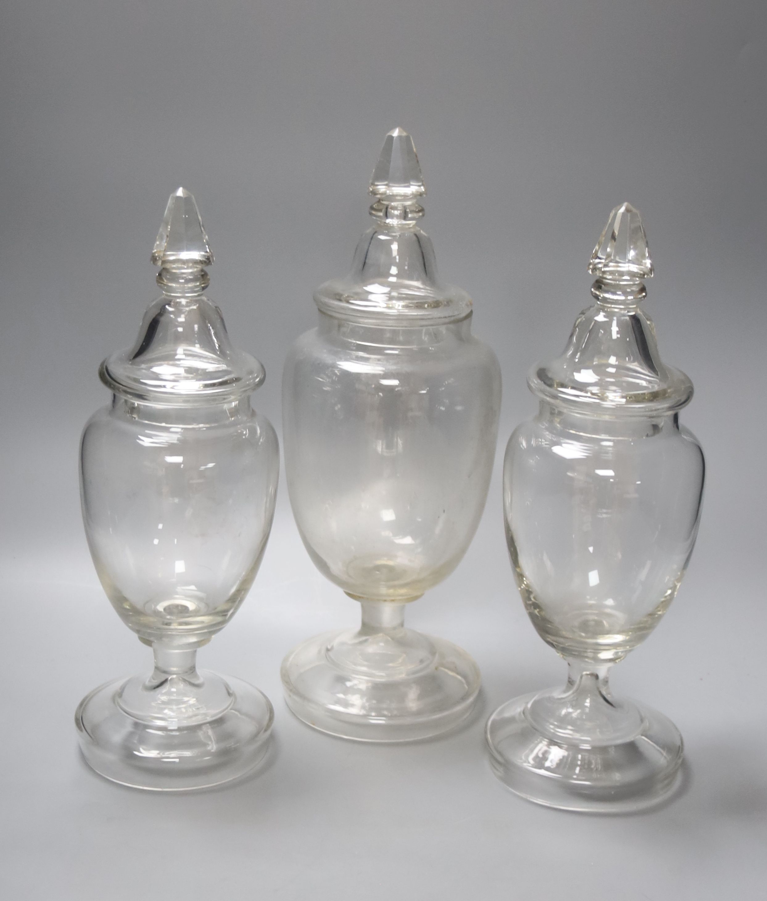 A garniture of three Victorian glass sweet jars, tallest 34cm